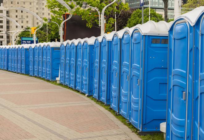 a line of portable restrooms at a sporting event, providing athletes and spectators with clean and accessible facilities in Akron